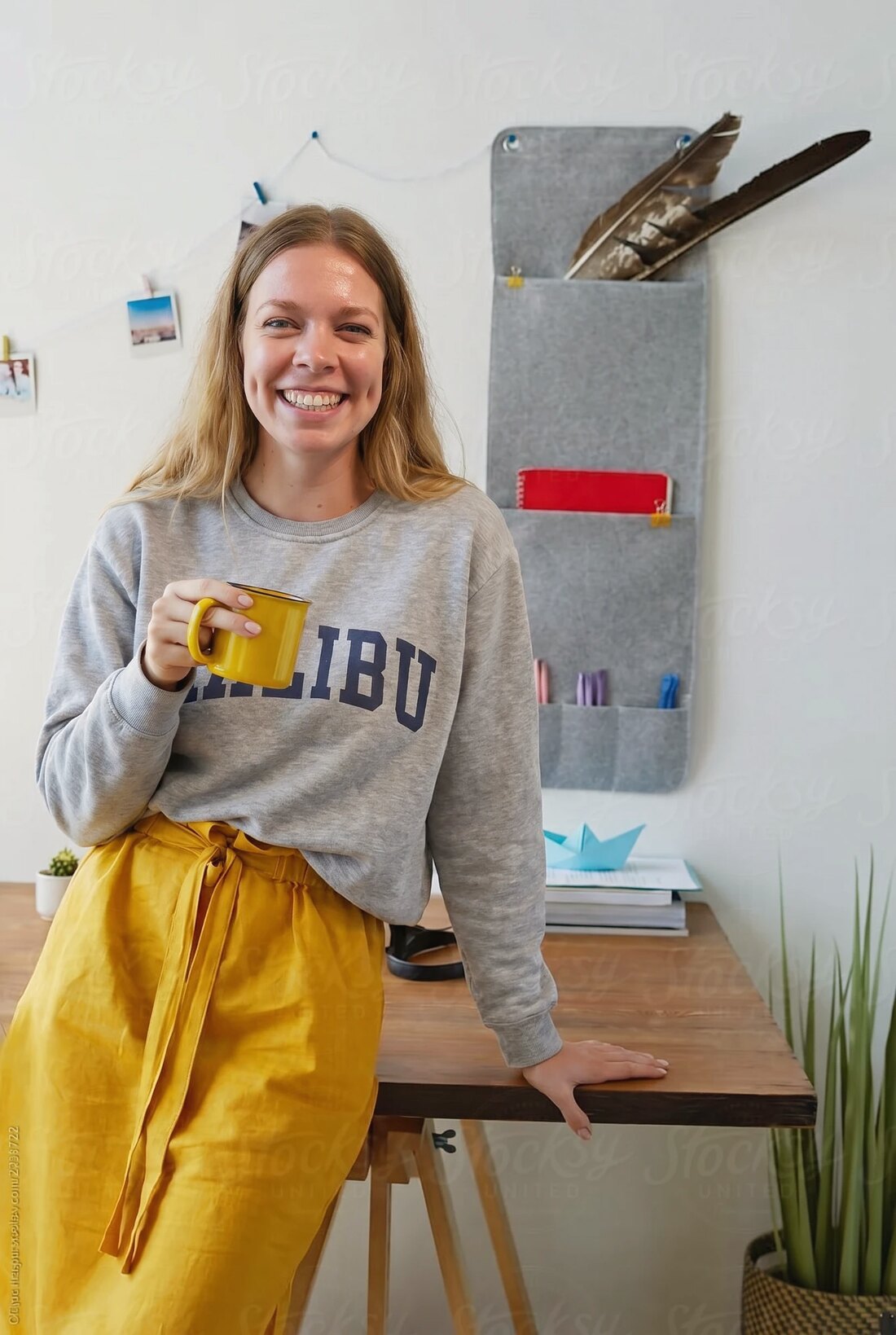 Lauren at home with a warm drink
